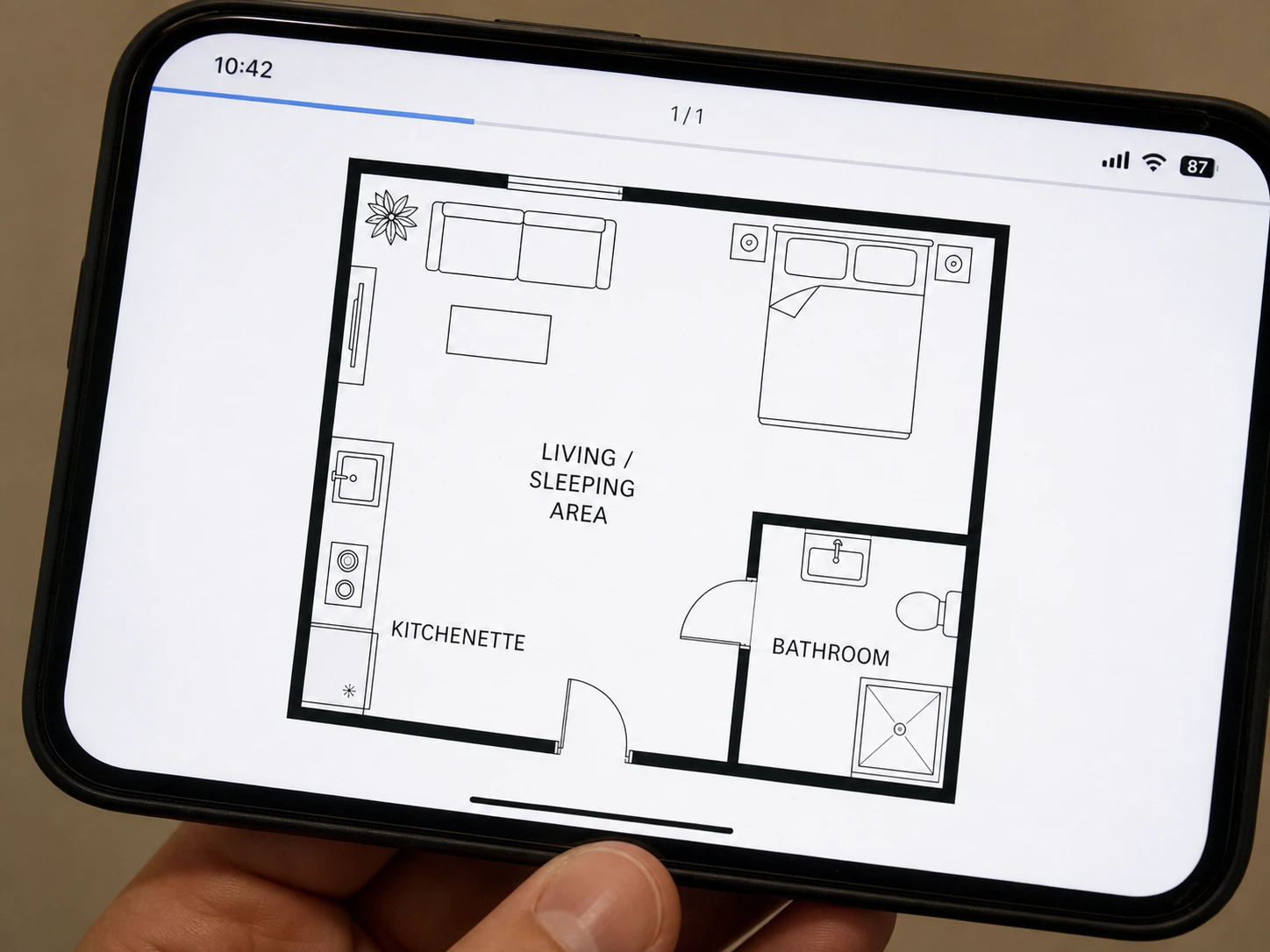 A pencil sketch of a studio flat redrawn as a labelled floor plan